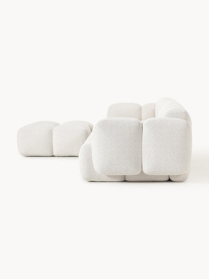 Modulares Sofa Tayla (4-Sitzer) aus Bouclé mit Hocker (links/rechts)